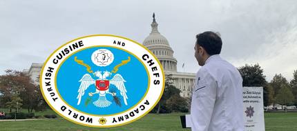 In chef whites before the United States Capitol; the WTCA seal at left, a Zeki Gülyiyen memorial banner in the background